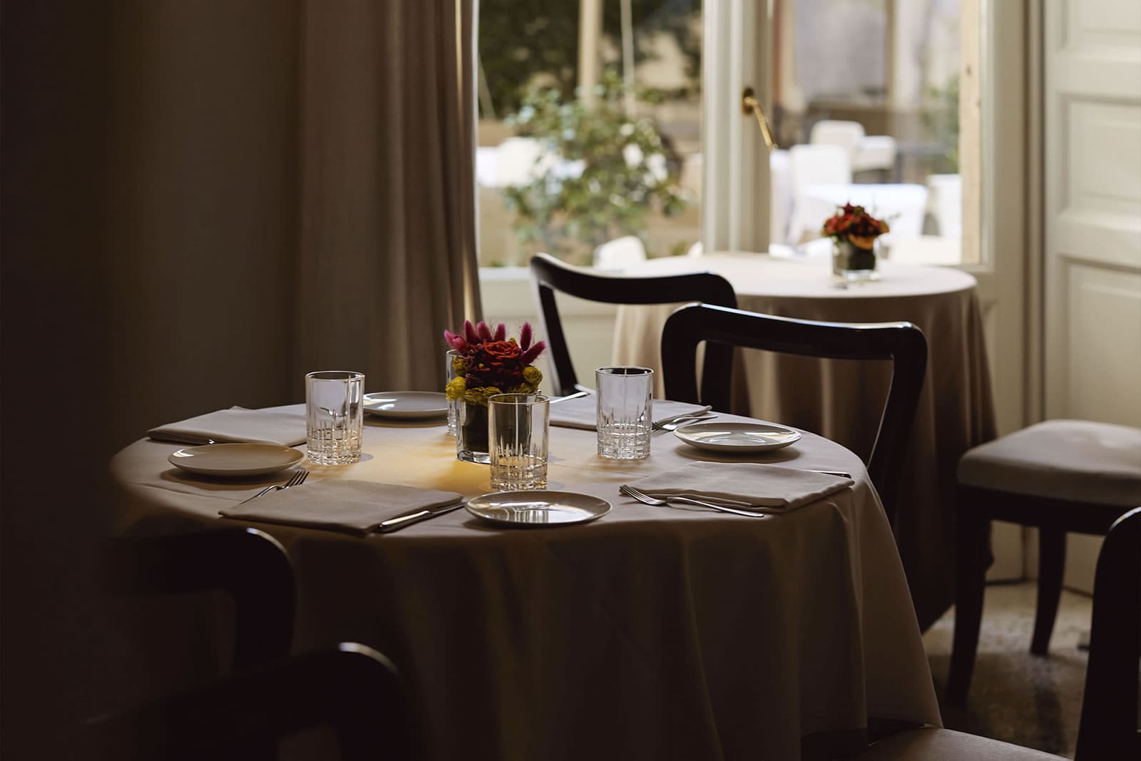 Spacious restaurant view with elegant tables and greenery