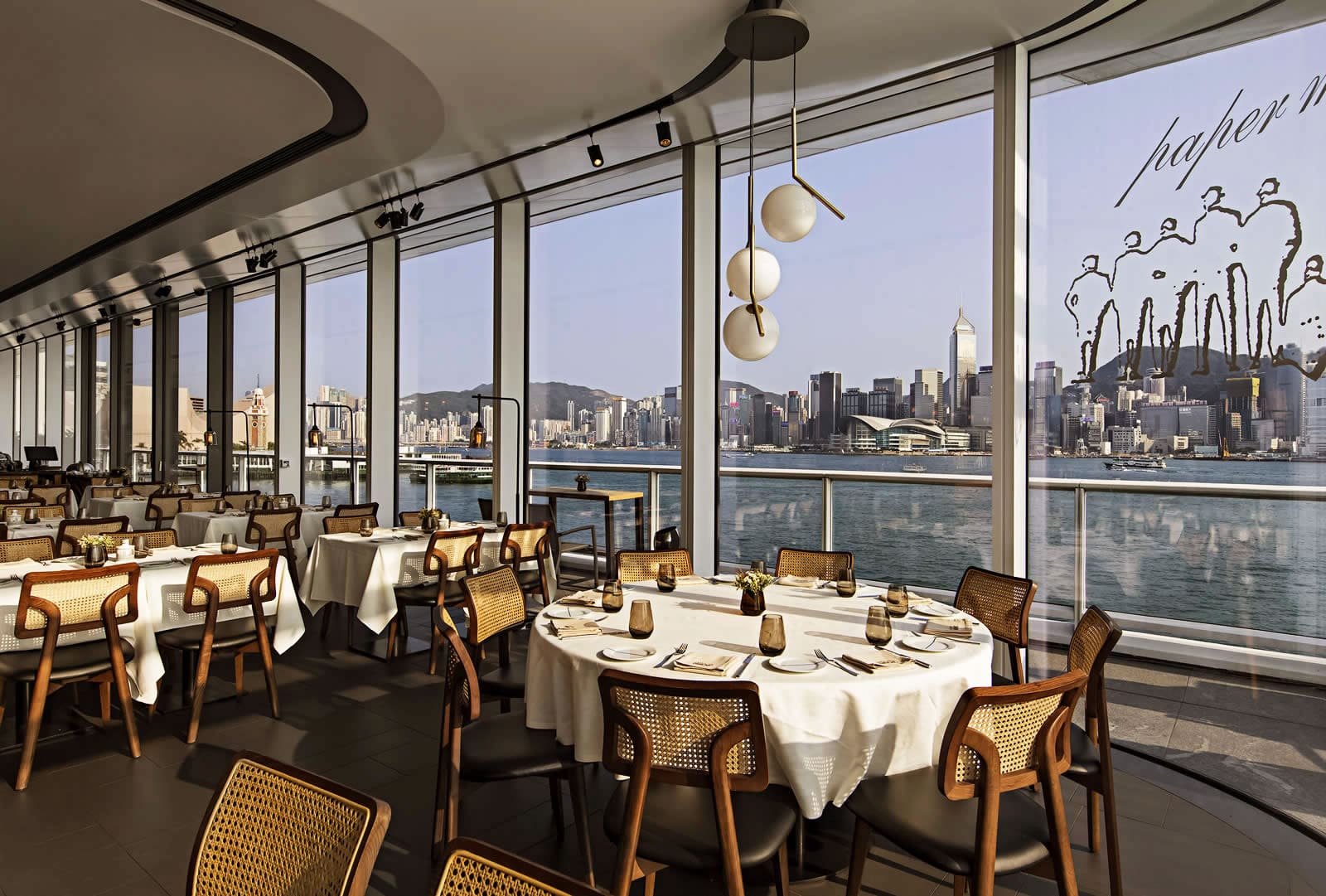 Elegant table setting at Paper Moon Hong Kong with city skyline backdrop Elegant table setting at Paper Moon Hong Kong with city skyline backdrop